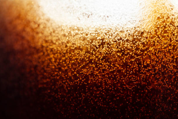 close-up bubbles and ice in a coke glass