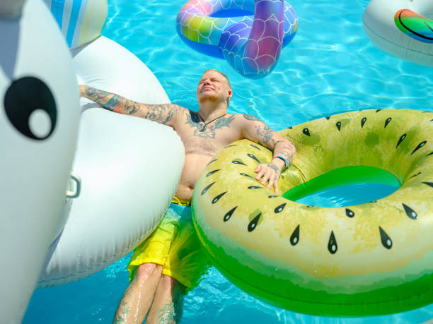 istock Transgender man at the pool party in the backyard 1322692779