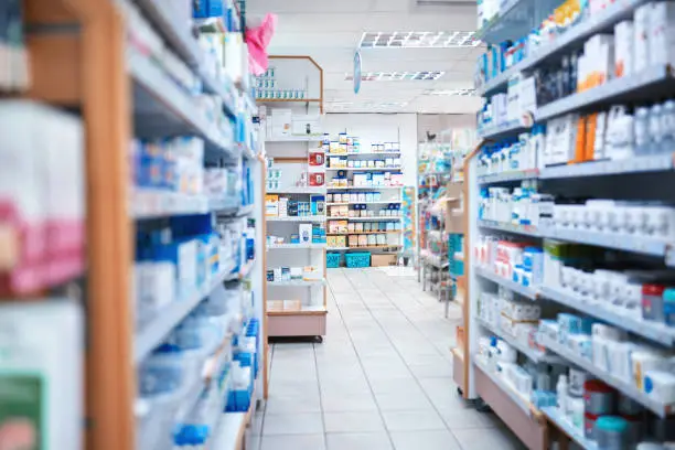 Photo of Cropped shot of shelves stocked with various medicinal products in a pharmacy