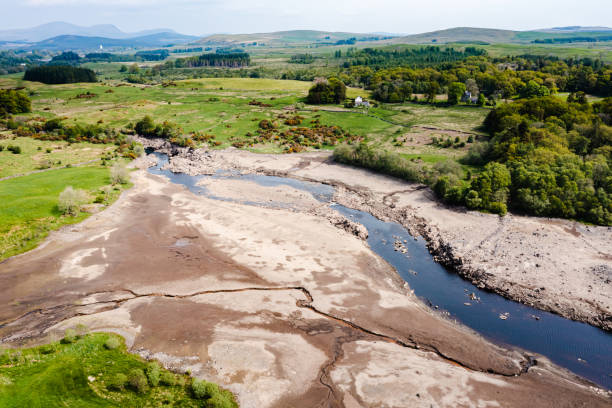Drone view of low water levels on a Scottish loch Drone view of low water levels on a Scottish loch to allow for maintenance on a hydro dam Galloway Hills stock pictures, royalty-free photos & images