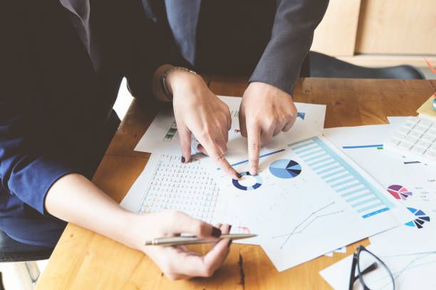 istock An auditor  pointing to documents to examine budgets and financial fraud. 1322695080