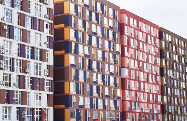 istock Architectural texture - four colorful multi-storey buildings with many windows. Modern residential building architecture, background, texture. 1322696005