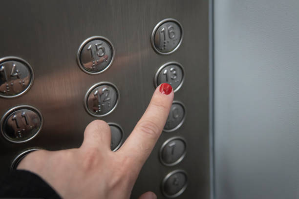 istock red manicured finger presses the elevator button. A trip to the 13th floor. 1322697310