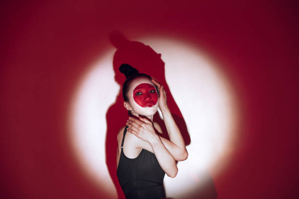 istock Ballet dancer dancing over red studio background. Modern design. Contemporary colorful conceptual light as rising sun at Japan. 1322700152