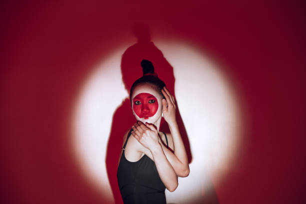 istock Ballet dancer dancing over red studio background. Modern design. Contemporary colorful conceptual light as rising sun at Japan. 1322700173