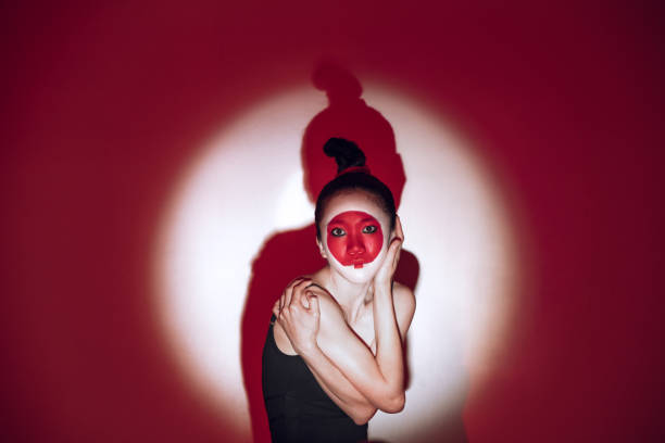 istock Ballet dancer dancing over red studio background. Modern design. Contemporary colorful conceptual light as rising sun at Japan. 1322700179