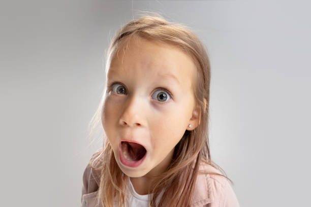 istock Beautiful little girl looking suprised on pastel studio background 1322700477