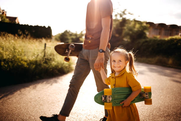 istock Father and daughter skate 1322700978