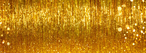 istock Festive gold tinsel glitters. Web banner, background for your design 1322701946
