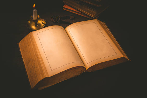 istock Old antique book with empty pages and candle in vintage style 1322704702