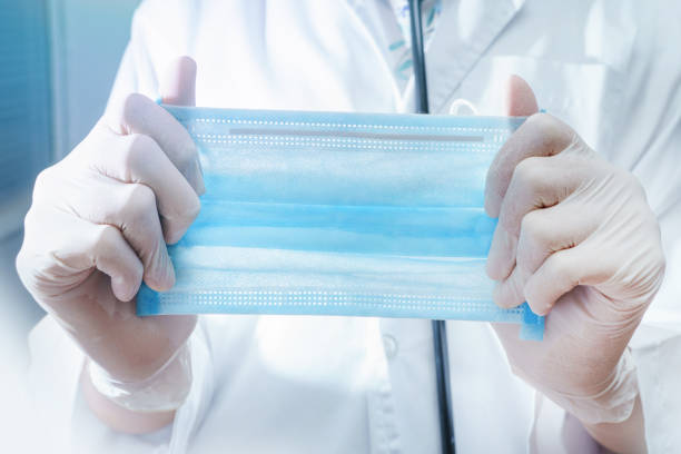 istock doctor holding surgical mask in hands to camera 1322705483
