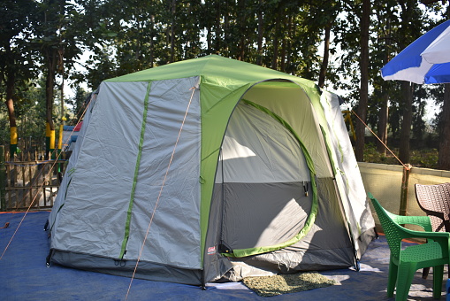 Closeup image of a tent in between a forest