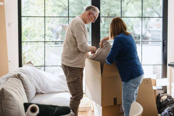 istock A senior couple packing (or unpacking) boxes inside a house. 1322709152