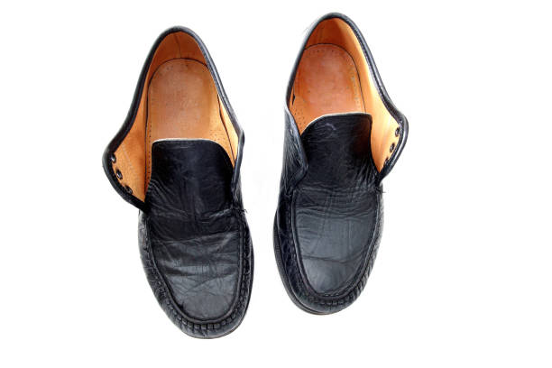 istock old black leather shoes isolated on white 1322709892