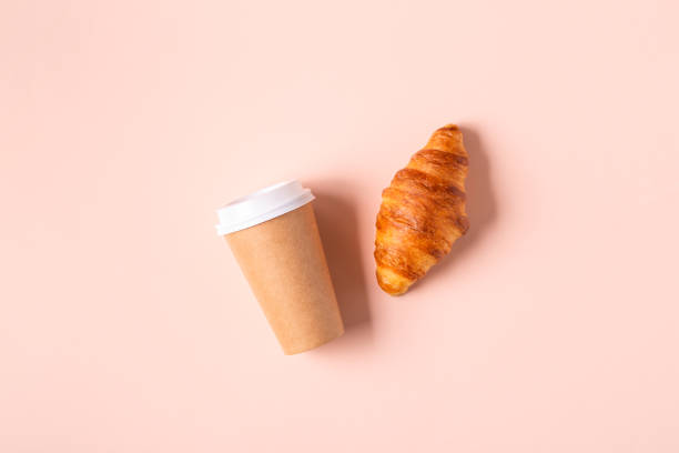 istock Coffee to go in a paper cup with croissants 1322710151
