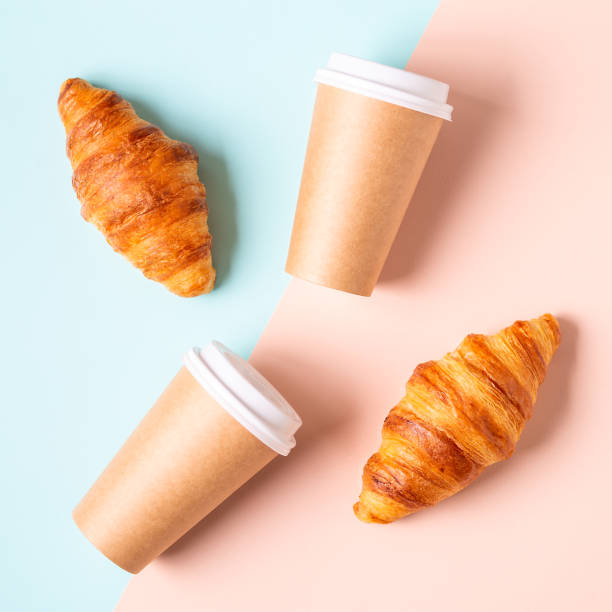 istock Coffee to go in a paper cup with croissants 1322710175