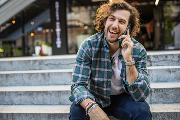 istock Young man outdoors, talking on the phone 1322712373