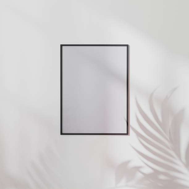 istock blank poster frame mock up on white wall with palm leaf shadow, 3d illustration 1322713280