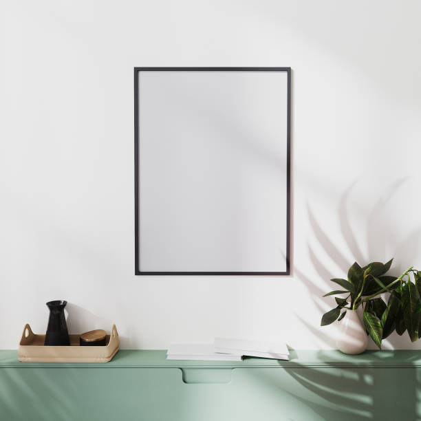 istock mock up poster frame on white wall with palm shadow and green cabinets with decoration, 3d illustration 1322713290