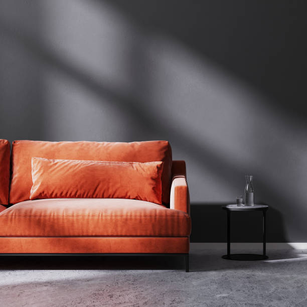 istock red sofa with black coffee table in empty room with black empty wall with sun rays, black empty wall, 3d rendering 1322713294