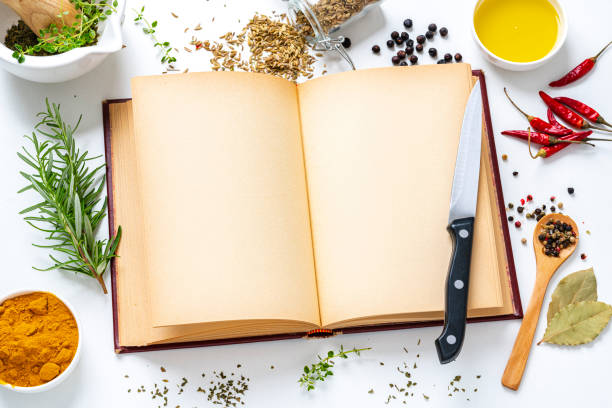 istock Cookbook with herbs and spices on white background 1322713626