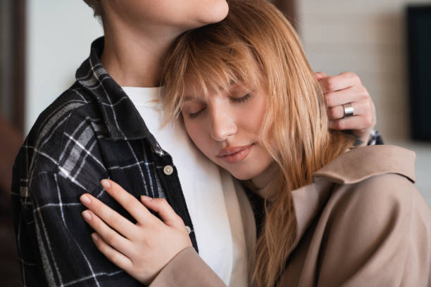 istock Love and care concept. Protection and passion between two lovers. Trustful relationship LGBT lesbians transgender girlfriends. Hugging and embracing 1322714601