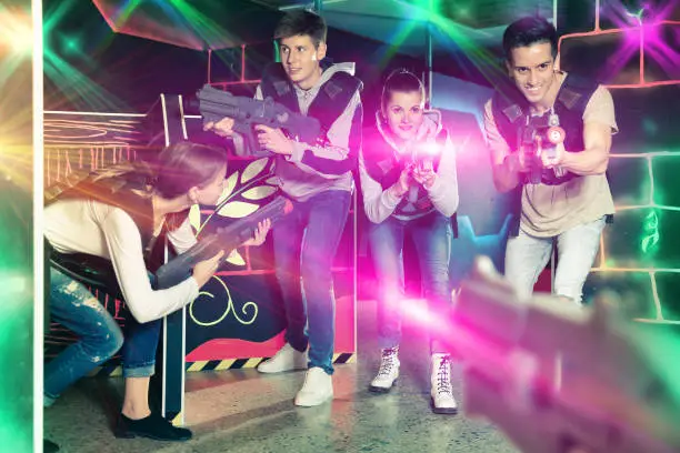 Photo of Young people playing laser tag