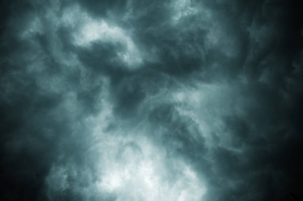 istock Thick dark black storm clouds covering summer sunset sky. Just before gale-speed wind started blowing before Nor'westers Kalbaishakhi Bordoisila thunderstorm torrential rain. Atmospheric background. 1322716118