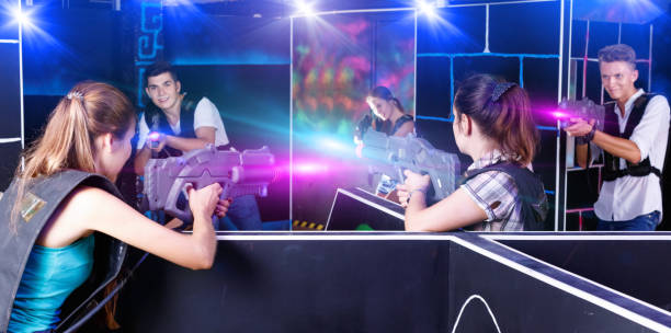 istock Two laser tag teams playing enthusiastically and aiming at each 1322716420