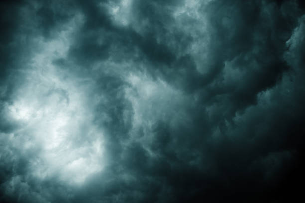 istock Thick dark black storm clouds covering summer sunset sky. Just before gale-speed wind started blowing before Nor'westers Kalbaishakhi Bordoisila thunderstorm torrential rain. Atmospheric background. 1322716426
