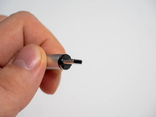 istock The usb type C cable is collapsible with a magnetic attachment in man hand on a white background. Copy space 1322717648
