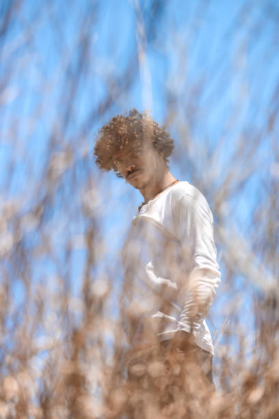 istock A young man in a white sweater enjoys nature 1322718936