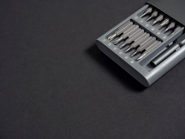 istock A set of screwdrivers with bits in a case on a dark background. Close up, flat lay, tools for work, copy space. 1322719159