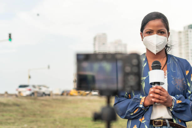 istock presenter in face mask speaking into microphone 1322720453