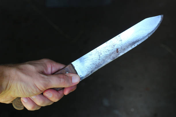 istock Knife in the hands of a criminal or murderer. 1322721299