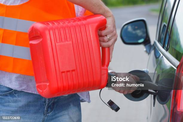Driver Fills The Fuel In An Empty Car Tank From Canister Stock Photo - Download Image Now