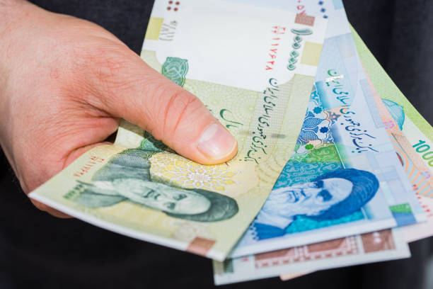 istock Iranian Riyal Money, Various Values, Banknotes spread out and held in the hand 1322722870