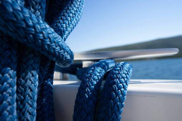 Blue double braided rope Blue double braided rope on a tied on a cleat catamaran sailing stock pictures, royalty-free photos & images