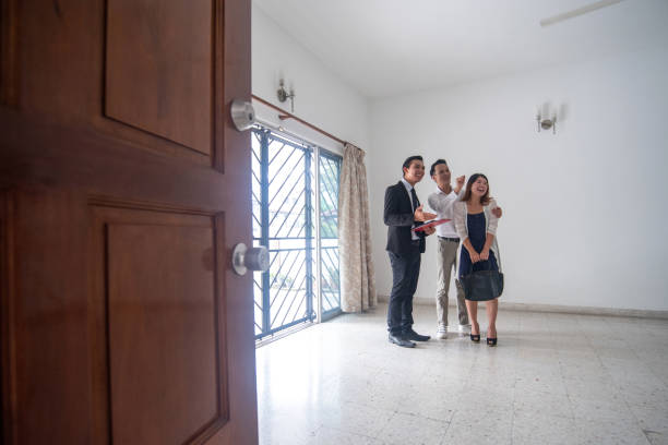 istock Real estate agent showing new home to clients 1322723015