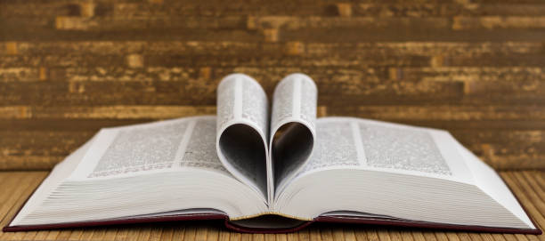 istock The book is on the table. Heart from book pages. 1322723176