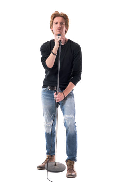 istock Cool macho stylish rocker singer holding microphone on stand 1322723705