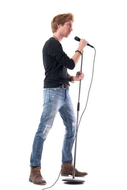 istock Side view of rock music singer singing on microphone. 1322723862