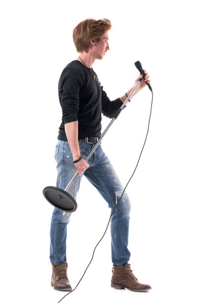 istock Profile view of rocker singer holding microphone looking away 1322723872