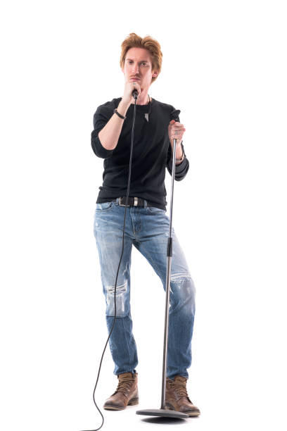 istock Handsome confident rock music singer holding microphone looking at camera 1322724024