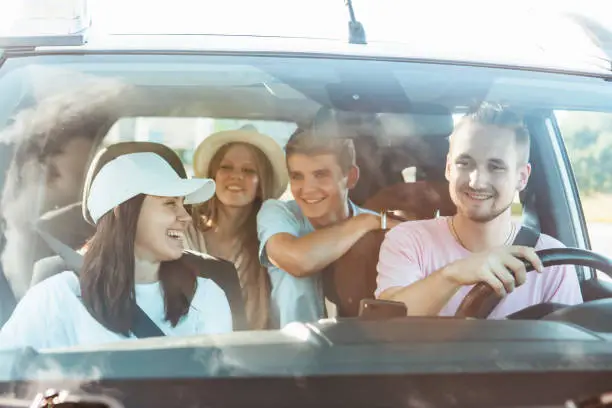 group of friends in car. road trip concept. summer vacation. friendship