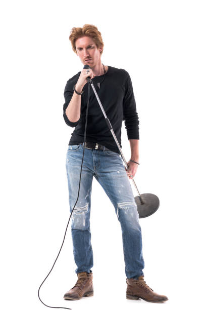 istock Tough macho rock music male singer carrying microphone looking at camera 1322724148
