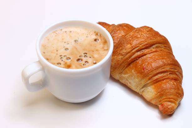 istock Cappuccino in a cup and croissant. Popular breakfast. 1322724243