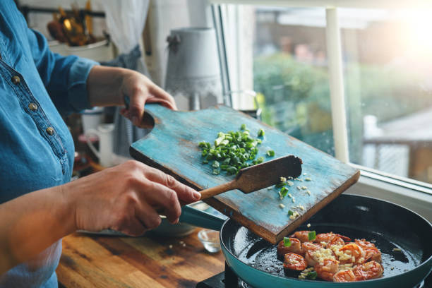 istock Preparing Shrimp and Grits in Domestic Kitchen 1322726155