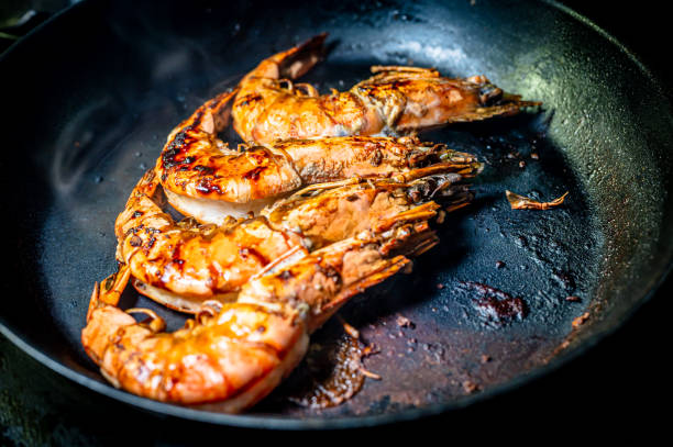 istock Grilled prawn in a frying pan on a dark background. Seafood appetizer. 1322727791