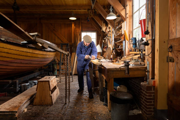 istock Senior wooden boat builder at traditional boat yard 1322728687